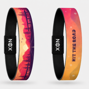 XOIN Hit The Road Premium Wristband featuring scenic sunset landscape and travel-inspired artwork