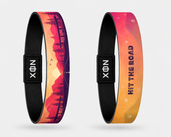 XOIN Hit The Road Premium Wristband featuring scenic sunset landscape and travel-inspired artwork