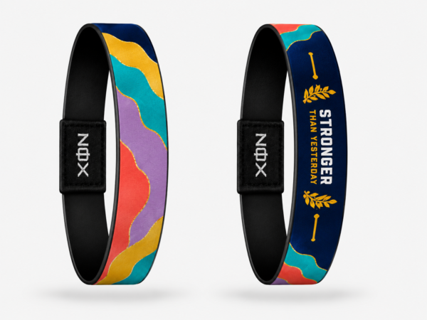 XOIN Stronger Than Yesterday Premium Wristband featuring colorful artwork and motivational message